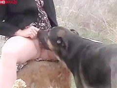 Blonde mature woman lets dog licking pussy on trip out